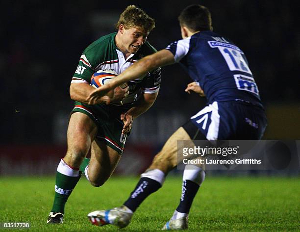 Tom Youngs of Leicester Tigers is tackled by Chris Bell of Sale during the EDF Energy Cup match between Leicester Tigers and Sale Sharks at Welford...