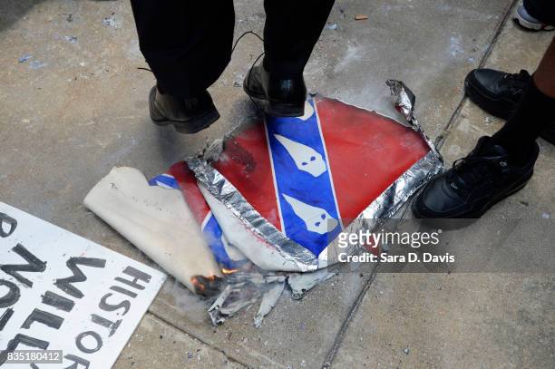Demonstrators jump on an Confederate flag replica in reaction to a potential white supremacists rally on August 18, 2017 in Durham, North Carolina....