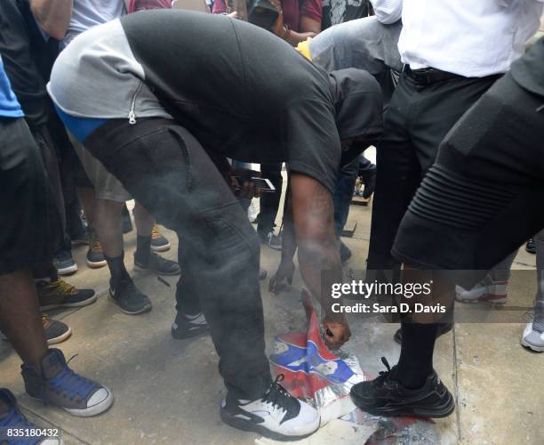 Demonstrators tear up a Confederate flag replica in reaction to a potential white supremacists rally on August 18, 2017 in Durham, North Carolina....