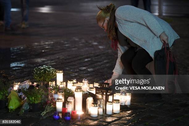 Flowers and candles are left at the Turku Market Square in the Finnish city of Turku where several people were stabbed on August 18, 2017. Two people...