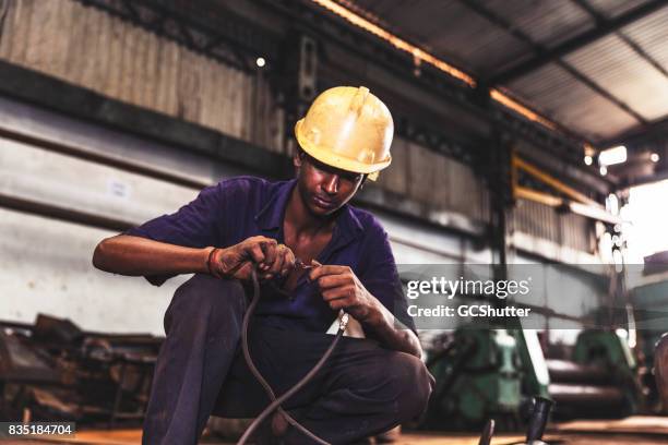 youth fixing the cable in a workshop - cabling stock pictures, royalty-free photos & images