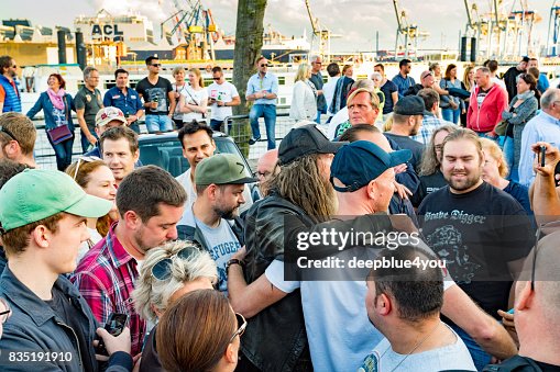 A man takes a photo of Magnus Walker and his fans on the Fischmarkt Hamburg A man takes a photo of Magnus Walker and his fans on the Fischmarkt Hamburg