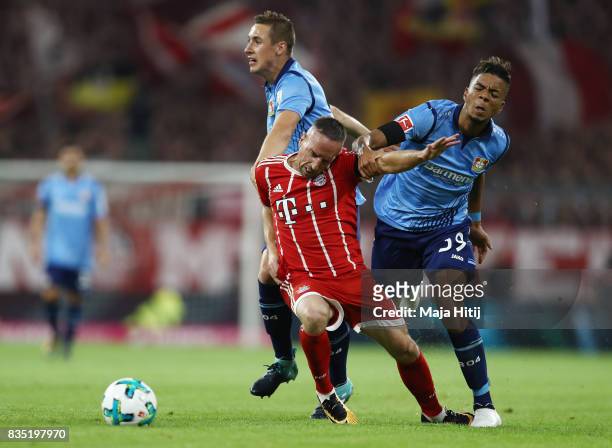 Franck Ribery of Bayern Muenchen with Benjamin Henrichs of Bayer Leverkusen and Dominik Kohr of Bayer Leverkusen during the Bundesliga match between...
