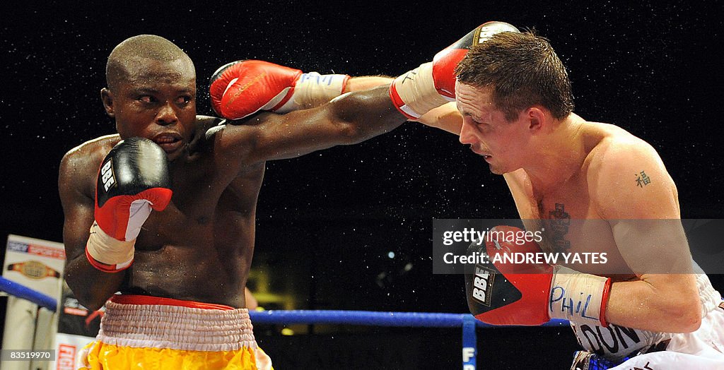 Don Broadhurst of England (R) vies with