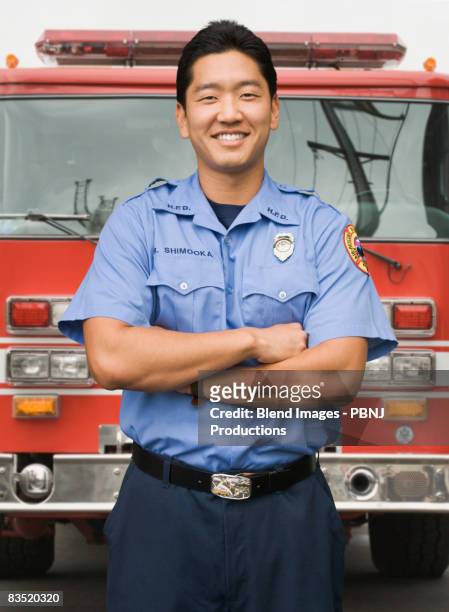 asian firefighter next to fire truck - firefighting ストックフォトと画像