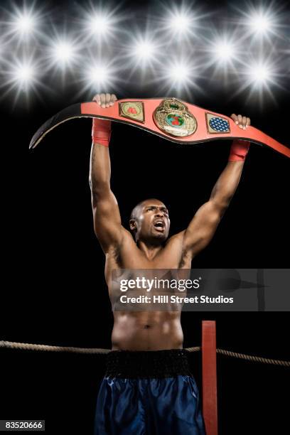 african boxer lifting championship belt - championship belt stockfoto's en -beelden