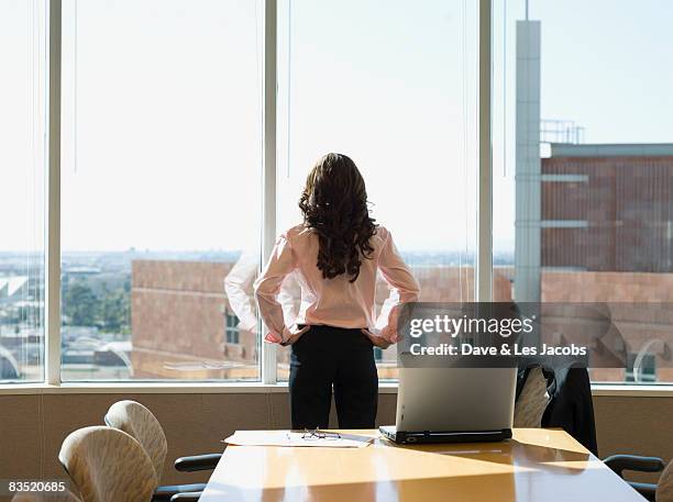 mixed race businesswoman standing in conference room - patience office stock pictures, royalty-free photos & images