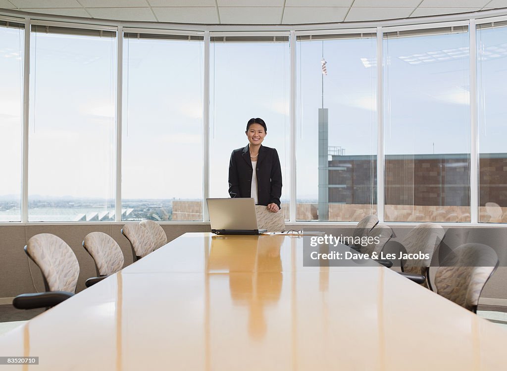 Asian businesswoman standing in conference room