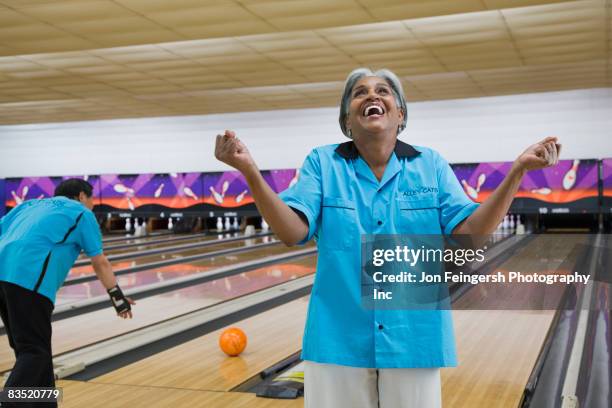 african woman cheering in bowling alley - womens champions league stock pictures, royalty-free photos & images