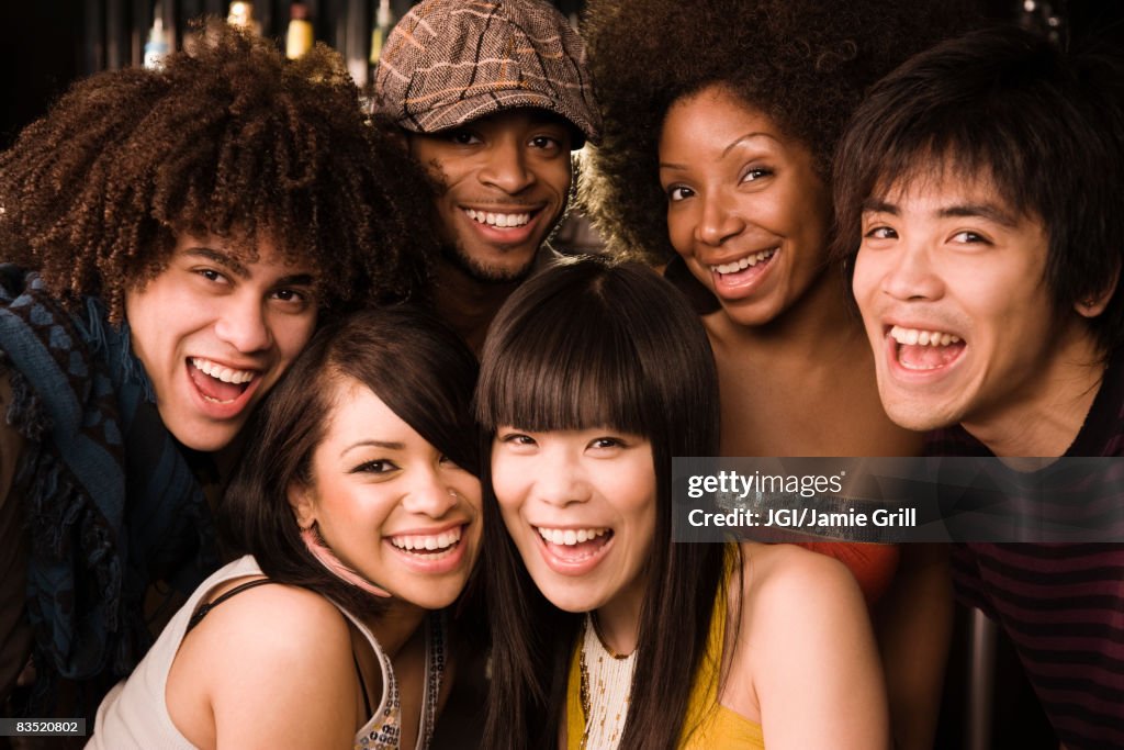 Multi-ethnic friends posing in nightclub