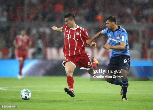 Robert Lewandowski of Bayern Muenchen with Aleksandar Dragovic of Bayer Leverkusen during the Bundesliga match between FC Bayern Muenchen and Bayer...