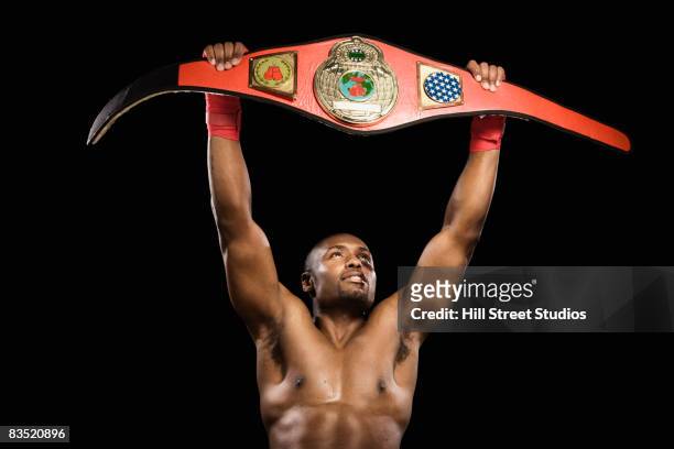 african boxer lifting championship belt - belt stock pictures, royalty-free photos & images