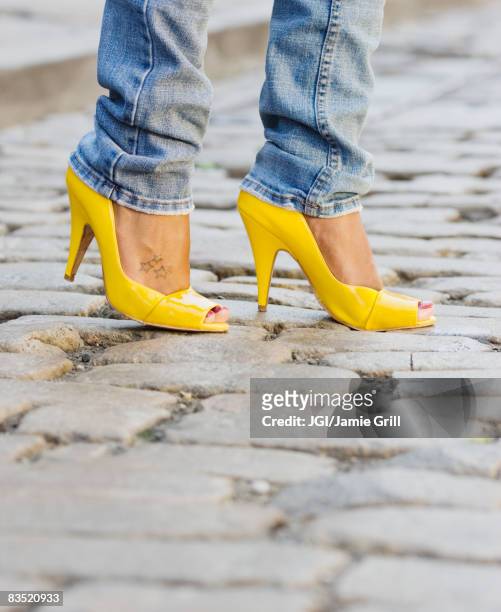 close up of african woman wearing yellow high heels - yellow shoe stock pictures, royalty-free photos & images
