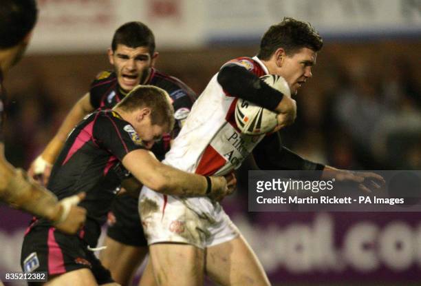 St Helens' Matt Gidley is tackled by Salford's Malcolm Alker during the engage Super League match at Knowsley Road, St Helens.