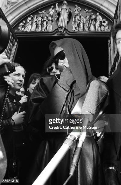 Jamaican American singer, model and actress, Grace Jones, wearing dark sunglasses emerges from St. Patrick's Cathedral, surrounded by photographers...