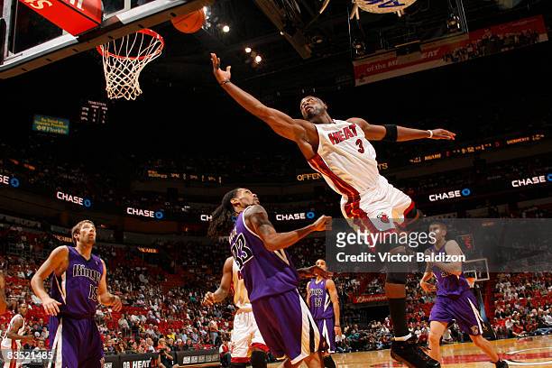 Dwyane Wade of the Miami Heat shoots against Mikki Moore of the Sacramento Kings on October 31, 2008 at the American Airlines Arena in Miami,...