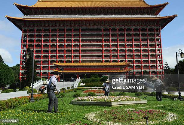 Workers maintain the guarden in front of the Grand Hotel where Chen Yunlin, head of China's Association for Relations Across the Taiwan Straits, will...