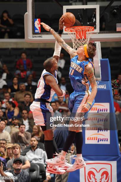 Cuttino Mobley of the Los Angeles Clippers goes up for a dunk against Chris Andersen of the Denver Nuggets at Staples Center on October 31, 2008 in...