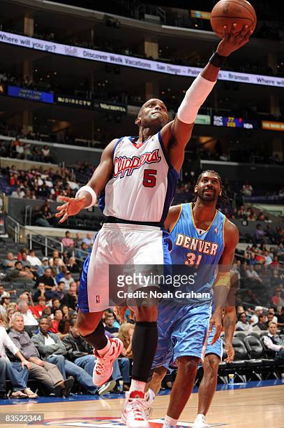 Cuttino Mobley of the Los Angeles Clippers goes up for a shot while Nene of the Denver Nuggets looks on during their game at Staples Center on...