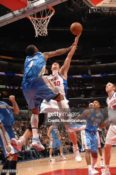 Smith of the Denver Nuggets contests the shot of Paul Davis of the Los Angeles Clippers at Staples Center on October 31, 2008 in Los Angeles,...