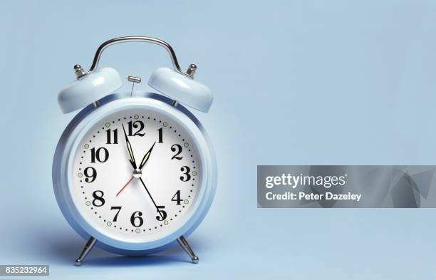 blue alarm clock - objects on coloured background stock pictures, royalty-free photos & images