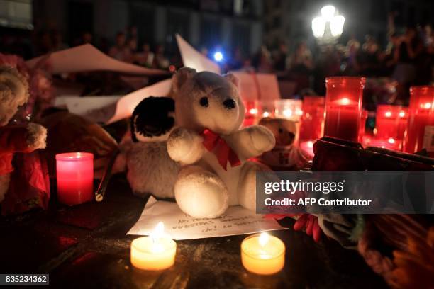 Picture taken on August 18, 2017 shows tributes to the victims of the attack of Barcelona set up at the Font de Canaletes in Barcelona as they pay...