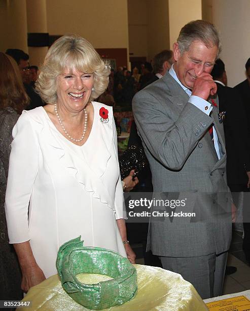 Camilla, Duchess of Cornwall and Prince Charles, Prince of Wales laugh as they are taken on a tour of Brunei Darussalam University on November 1,...