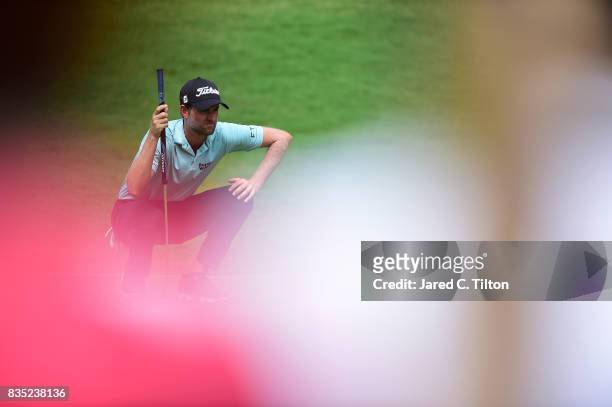 Webb Simpson lines up a putt on the eighth green during the second round of the Wyndham Championship at Sedgefield Country Club on August 18, 2017 in...