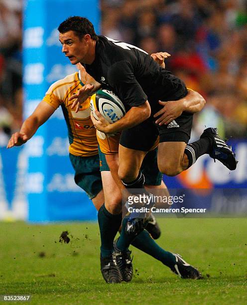 Dan Carter of the All Blacks is tackled during the Bledisloe Cup match between the Australian Wallabies and the New Zealand All Blacks at Hong Kong...