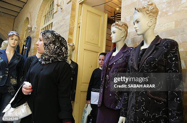 An Iraqi woman shops for winter clothes at the Khan al-Khudaiyer shopping center close to the Tigris River in the old quarter of Baghdad on November...