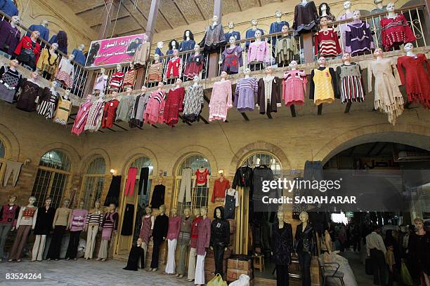 Winter clothes are on sale at the Khan al-Khudaiyer shopping center close to the Tigris River in the old quarter of Baghdad on November 01 2008. The...