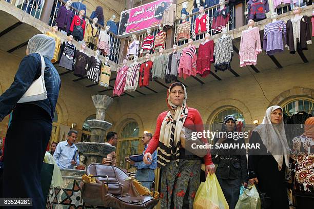 Iraqi women shop for winter clothes are on sale at the Khan al-Khudaiyer shopping center close to the Tigris River in the old quarter of Baghdad on...