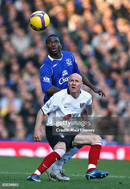 Andrew Johnson of Fulham holds off a challenge from Joseph Yobo of Everton during the Barclays Premier League match between Everton and Fulham at...