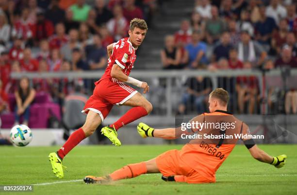 Thomas Mueller of Bayern Muenchen sees a shot saved by Bernd Leno of Bayer Leverkusen during the Bundesliga match between FC Bayern Muenchen and...
