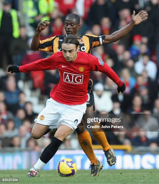 Dimitar Berbatov of Manchester United clashes with George Boateng of Hull City during the Barclays Premier League match between Manchester United and...