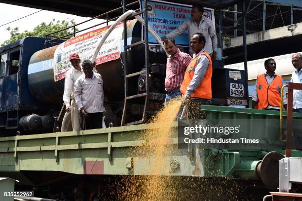 Worker sprays insecticide on area near track with the help of hose from special train on August 18, 2017 in New Delhi, India. Delhi Division Northern...