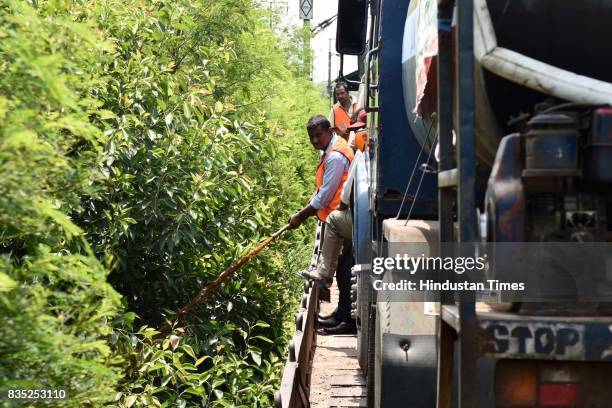 Worker sprays insecticide on area near track with the help of hose from special train on August 18, 2017 in New Delhi, India. Delhi Division Northern...