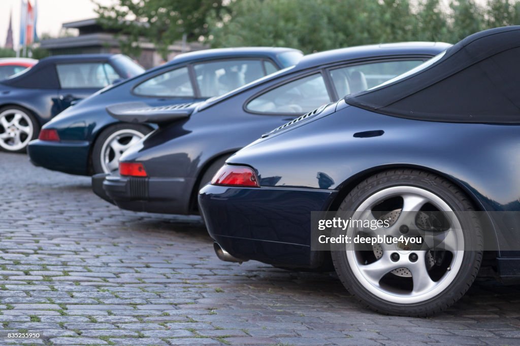 A series of different porsche 911 vehicles parked during the Magnus Walker event on the Hamburg Fischmarkt