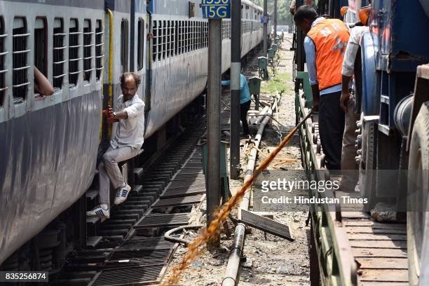 Worker sprays insecticide on area near track with the help of hose from special train on August 18, 2017 in New Delhi, India. Delhi Division Northern...
