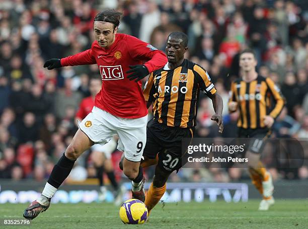 Dimitar Berbatov of Manchester United clashes with George Boateng of Hull City during the Barclays Premier League match between Manchester United and...