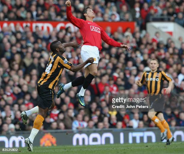 Cristiano Ronaldo of Manchester United clashes with Kamil Zayatte of Hull City during the Barclays Premier League match between Manchester United and...