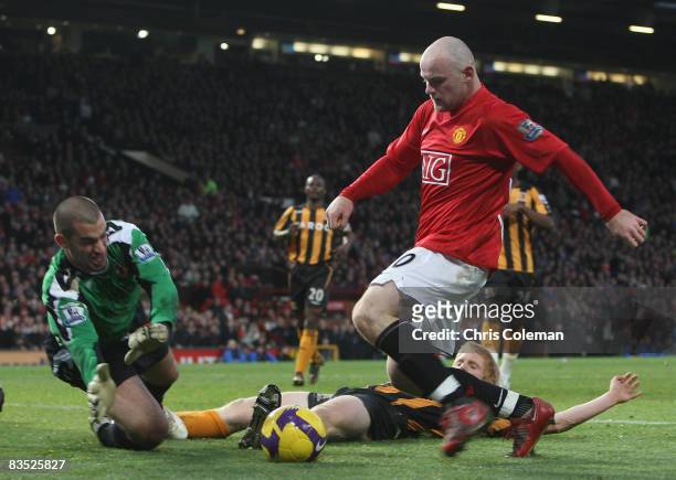 Wayne Rooney of Manchester United clashes with Boaz Myhill of Hull City walks off after the Barclays Premier League match between Manchester United...