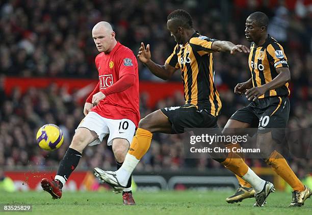 Wayne Rooney of Manchester United clashes with Kamil Zayatte of Hull City walks off after the Barclays Premier League match between Manchester United...