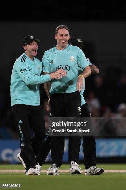 Rikki Clarke of Surrey celebrates with captain Gareth Batty after taking the wicket of Jimmy Neesham of Kent Spitfires during the NatWest T20 Blast...
