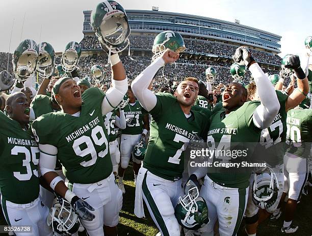 Brian Hoyer of the Michigan State Spartans celebrates with Jerel Worthy and Deon Curry after beating the Wisconsin Badgers 25-24 on November 1, 2008...