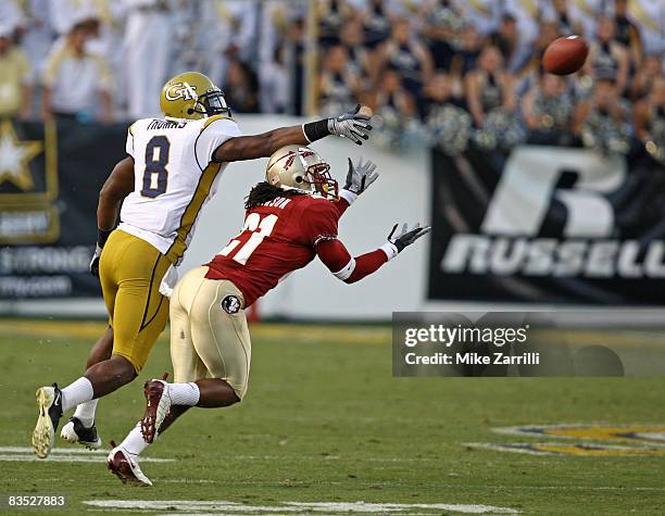 Cornerback Patrick Robinson of the Florida State Seminoles gets position to intercept a fourth quarter pass while wide receiver Demaryius Thomas of...