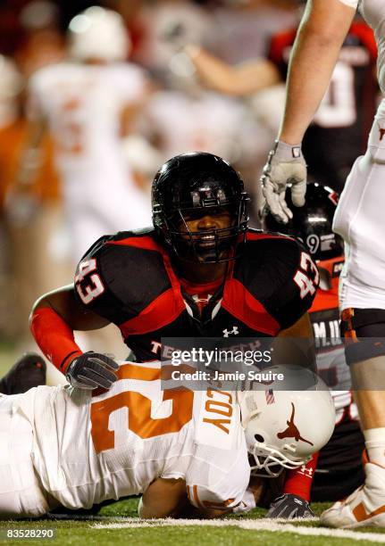 McKinner Dixon of the Texas Tech Red Raiders tackles sacks quarterback Colt McCoy of the Texas Longhorns during the first half of the game on...