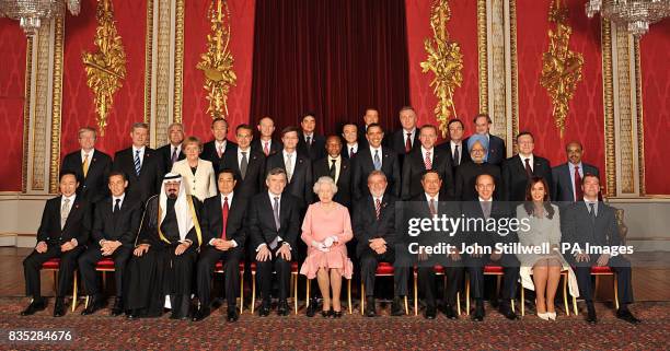 Queen Elizabeth II with delegates of the G20 London summit pose for a group picture in the Throne Room at Buckingham Palace. Back from left:...