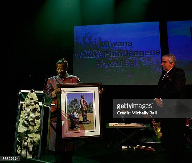 Prince Mangosuthu Buthulezi exchanges gifts with Colonel Peter Gooderson during the 80th bithday celebration of Prince Mangosuthu Buthulezi at the...