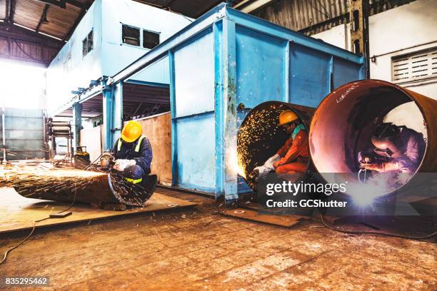 factory employees cooperating together to get their major project done on time - steel mill stock pictures, royalty-free photos & images